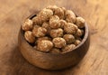 Bowl of Crunchy Asian Sesame Peanuts with Soy Sauce on a Wooden Counter Royalty Free Stock Photo