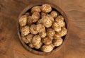 Bowl of Crunchy Asian Sesame Peanuts with Soy Sauce on a Wooden Counter Royalty Free Stock Photo