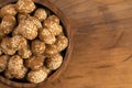 Bowl of Crunchy Asian Sesame Peanuts with Soy Sauce on a Wooden Counter Royalty Free Stock Photo