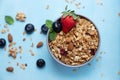 Bowl, cup with homemade granola or oatmeal granola with nuts and fresh strawberries and blueberries. Flakes and berries are Royalty Free Stock Photo