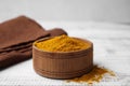 Bowl with curry powder on white wooden table, closeup Royalty Free Stock Photo