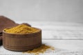 Bowl with curry powder on white wooden table, closeup. Space for text Royalty Free Stock Photo