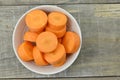 Bowl with cut carrots thick on wooden Royalty Free Stock Photo