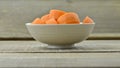Bowl with cut carrots thick on wooden Royalty Free Stock Photo