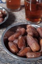 Bowl of dates fruit and glass of tea Royalty Free Stock Photo