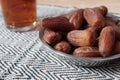 Bowl of dates fruit and glass of tea Royalty Free Stock Photo