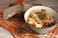 A bowl of delcious homemade stew with potato, turnip, sausages, celery, and onion. Served with fresh bread. European kitchen Royalty Free Stock Photo