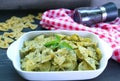 A Bowl of Homemade Farfalle Pasta with Pesto Sauce on Kitchen Table