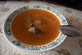 A bowl of delicious beef and barley soup with carrots, tomato, potato, celery, and peas. Tomato broth with meat Royalty Free Stock Photo