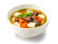 bowl of delicious chinese soup with vegetables and meat on white background