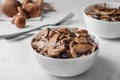 Bowl with delicious cooked mushrooms on white table Royalty Free Stock Photo