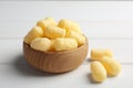 Bowl of delicious crispy corn sticks on wooden table