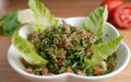A bowl of delicious fresh Tabbouleh tabbouli salad with parsley, mint, tomato, onion, olive oil and lemon juice Royalty Free Stock Photo
