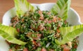 A bowl of delicious fresh Tabbouleh tabbouli salad with parsley, mint, tomato, onion, olive oil and lemon juice Royalty Free Stock Photo