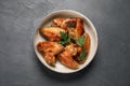 Bowl with delicious fried chicken wings on black table, top view Royalty Free Stock Photo
