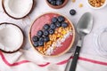 Bowl of delicious fruit smoothie served with fresh blueberries, granola and coconut flakes on white marble table, flat lay Royalty Free Stock Photo