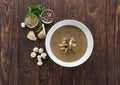 A bowl of delicious homemade creamy mushroom soup on wooden background, top view with fresh ingredients Royalty Free Stock Photo