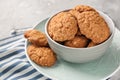 Bowl with delicious oatmeal cookies on table, closeup