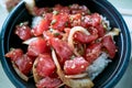 Bowl of delicious Poke, one of the main dishes of native Hawaiian cuisine served with diced raw fish and vegetables