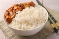 Bowl of delicious rice with meat, mushrooms and chopsticks on table Royalty Free Stock Photo