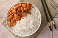 Bowl of delicious rice with meat, mushrooms and chopsticks on tiled table, flat lay Royalty Free Stock Photo