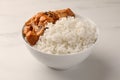 Bowl of delicious rice with meat and mushrooms on white marble table Royalty Free Stock Photo