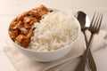 Bowl of delicious rice with meat and mushrooms on white table, closeup Royalty Free Stock Photo