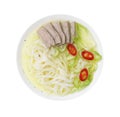 Bowl of delicious rice noodle soup with celery and meat isolated on white, top view Royalty Free Stock Photo