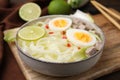 Bowl of delicious rice noodle soup with meat and egg on wooden board, closeup Royalty Free Stock Photo