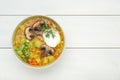 Bowl of delicious sauerkraut soup with mushrooms, green onion, dill and sour cream on white wooden table, top view. Space for text Royalty Free Stock Photo