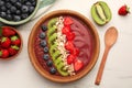 Bowl of delicious smoothie with fresh blueberries, strawberries, kiwi slices and oatmeal on white marble table, flat lay Royalty Free Stock Photo