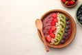 Bowl of delicious smoothie with fresh blueberries, strawberries, kiwi slices and oatmeal on white marble table, flat lay. Space Royalty Free Stock Photo