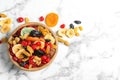 Bowl of different dried fruits on marble background, top view with space for text Royalty Free Stock Photo