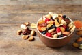 Bowl with different dried fruits and nuts on table Royalty Free Stock Photo