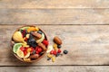 Bowl of different dried fruits on wooden background, top view with space for text Royalty Free Stock Photo