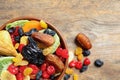 Bowl of different dried fruits on wooden background, top view with space for text Royalty Free Stock Photo