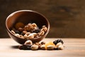 Bowl with different nuts and dried fruits on wooden table Royalty Free Stock Photo