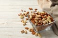 Bowl with different nuts on white wooden Royalty Free Stock Photo