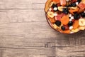 Bowl with different tasty dried fruits on wooden table, top view. Space for text Royalty Free Stock Photo