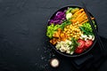 Bowl dish with brown rice, cucumber, tomato, green peas, red cabbage, chickpea, fresh lettuce salad and cashew nuts. Healthy balan Royalty Free Stock Photo