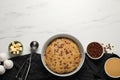 Bowl with dough and ingredients for cooking chocolate chip cookies on white marble table, flat lay. Space for text Royalty Free Stock Photo