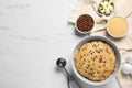 Bowl with dough and ingredients for cooking chocolate chip cookies on white marble table, flat lay. Space for text Royalty Free Stock Photo