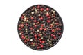 Bowl of dried aromatic peppercorns, isolated on white. Colourful pepper mix - black, red, green and white peppercorns.