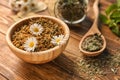 Bowl with dried chamomile flowers on wooden table Royalty Free Stock Photo