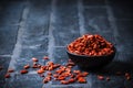 Bowl with dried Goji berries, chinese wolfberries, on black background Royalty Free Stock Photo