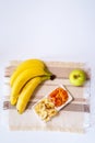 Bowl of dried organic banana chips with fresh bananas, dried apricots, Apple. snack Royalty Free Stock Photo