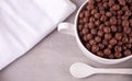 A bowl of dry chocolate balls cereal on the gray table for health breakfast Royalty Free Stock Photo