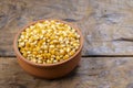Bowl of Dry Corn Kernels on Rustic Surface Royalty Free Stock Photo
