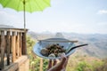 A bowl of Dry noodles with meatball, pork, vegetable and chopstick with beautiful Mountain view