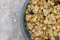 Bowl of dry organic breakfast cereal with dried blueberries and pumpkin seeds Royalty Free Stock Photo